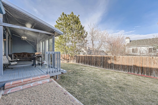 view of yard featuring fence and a deck