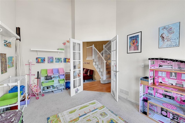 playroom featuring french doors and light colored carpet