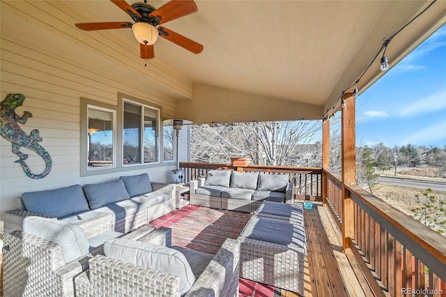 wooden terrace with an outdoor hangout area and ceiling fan