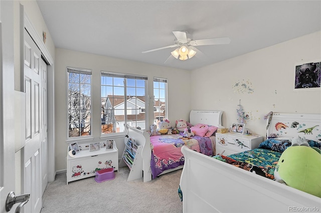 carpeted bedroom with a closet and ceiling fan