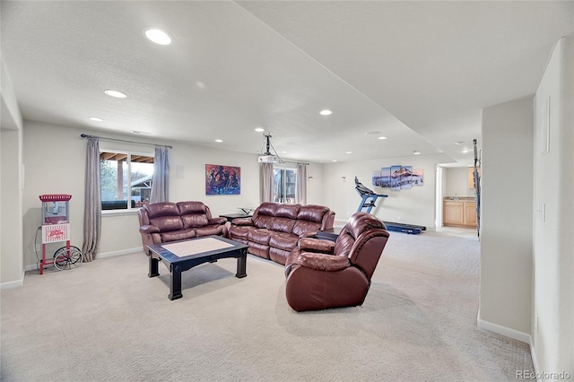 carpeted living room featuring a textured ceiling