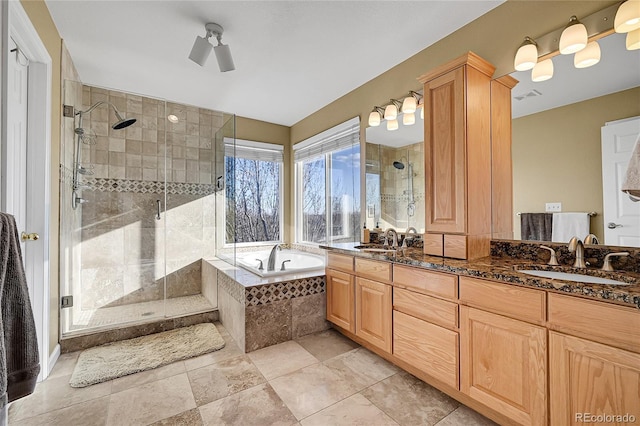 bathroom featuring ceiling fan, vanity, and independent shower and bath