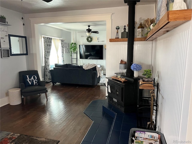 7651 State Highway 194, Las Animas, CO 81054 - living room featuring a wood stove, ceiling fan, and wood finished floors