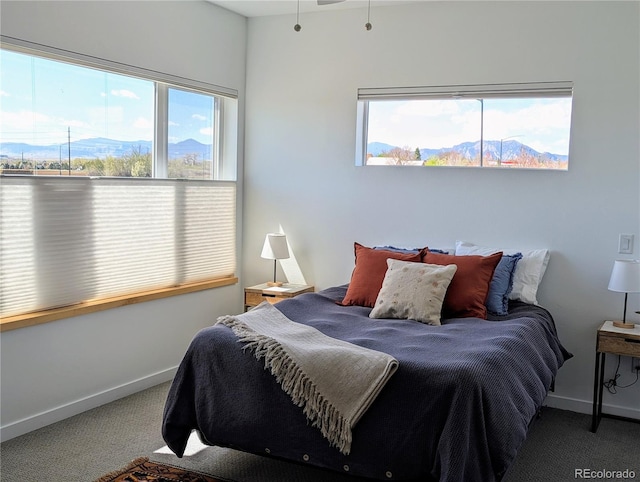bedroom featuring carpet floors, a mountain view, and baseboards