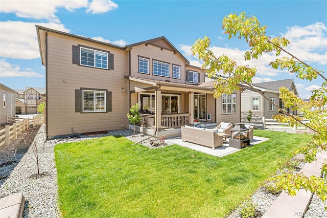 back of property with an outdoor living space and a lawn