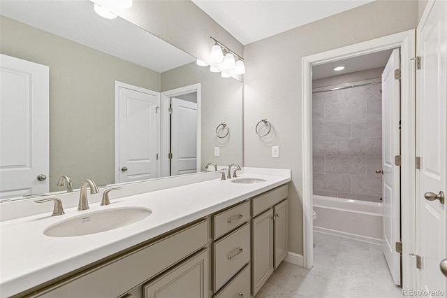 bathroom with tile patterned flooring, vanity, and tiled shower / bath combo