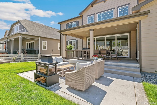 rear view of house with outdoor lounge area and a yard