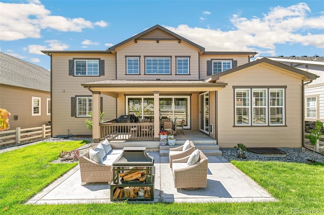 rear view of house featuring a patio area and a lawn