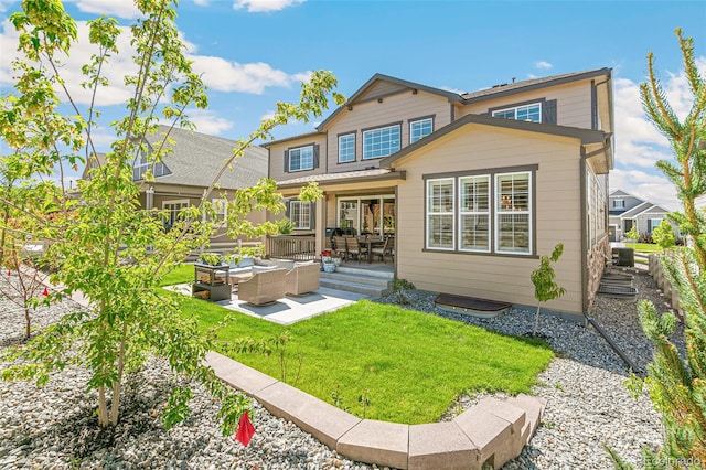 rear view of house featuring outdoor lounge area, a patio area, central air condition unit, and a yard