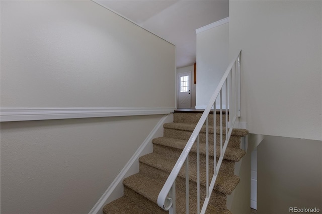 staircase featuring baseboards