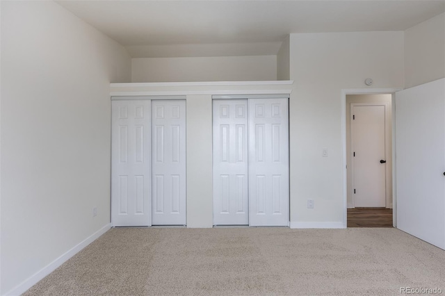 unfurnished bedroom featuring carpet flooring and baseboards