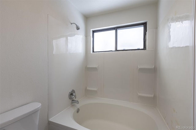 bathroom featuring toilet and bathing tub / shower combination