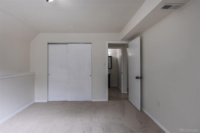 unfurnished bedroom with carpet floors, a closet, visible vents, and baseboards