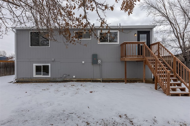 snow covered property featuring stairs