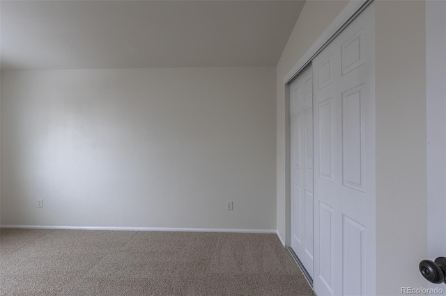 unfurnished bedroom featuring carpet floors, a closet, and baseboards