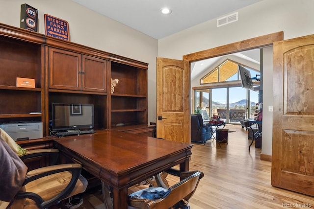 office featuring light wood-style floors, recessed lighting, visible vents, and vaulted ceiling