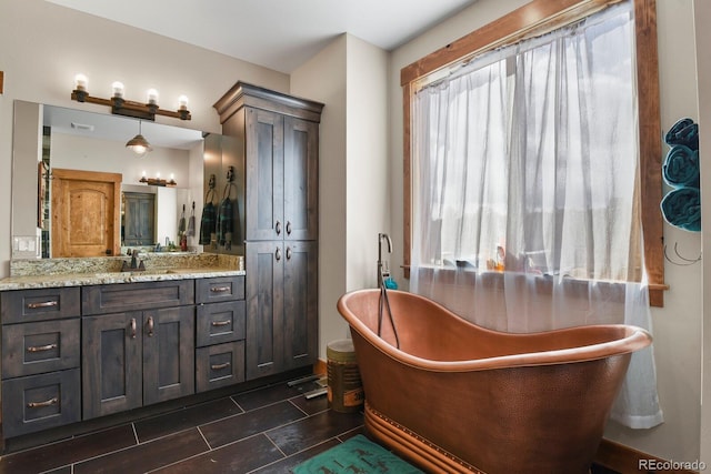 bathroom featuring a freestanding bath and vanity