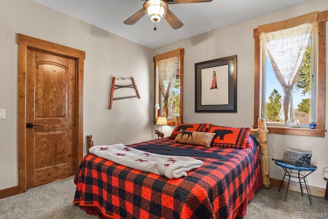 carpeted bedroom featuring ceiling fan and baseboards