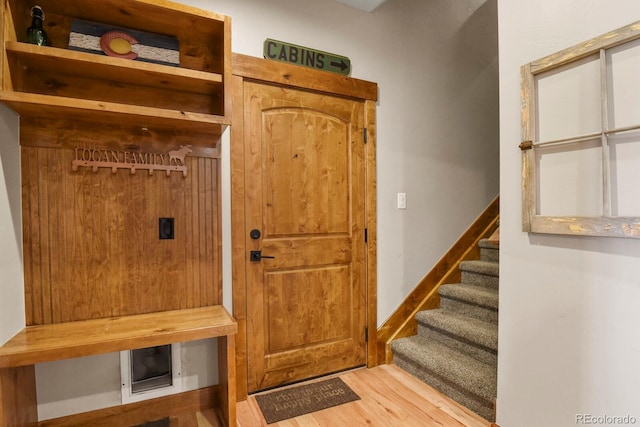 mudroom featuring baseboards and wood finished floors