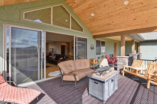 deck with an outdoor living space with a fire pit