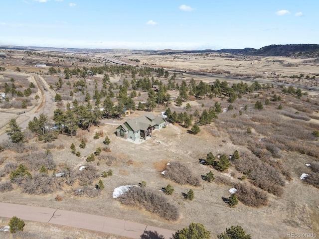 aerial view featuring a desert view and a mountain view