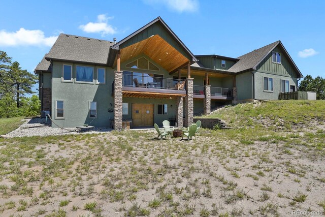 5800 Elk View Ct, Larkspur, CO 80118 - back of house featuring a fire pit, a wooden deck, stucco siding, and roof with shingles