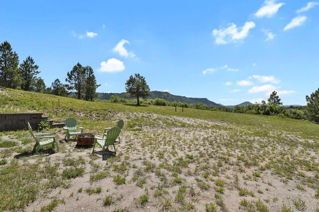 5800 Elk View Ct, Larkspur, CO 80118 - view of yard featuring an outdoor fire pit, a mountain view, and a view of countryside