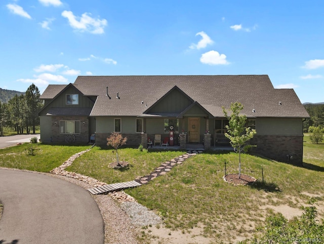 5800 Elk View Ct, Larkspur, CO 80118 - craftsman house featuring brick siding, a front yard, and roof with shingles