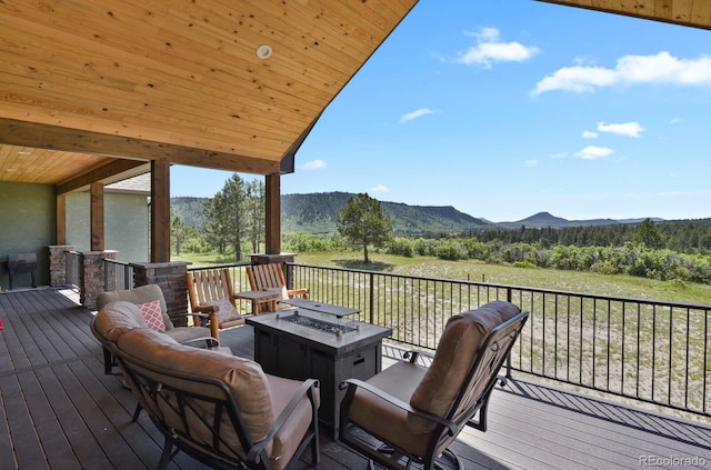 5800 Elk View Ct, Larkspur, CO 80118 - wooden deck featuring an outdoor fire pit, a mountain view, and a view of trees