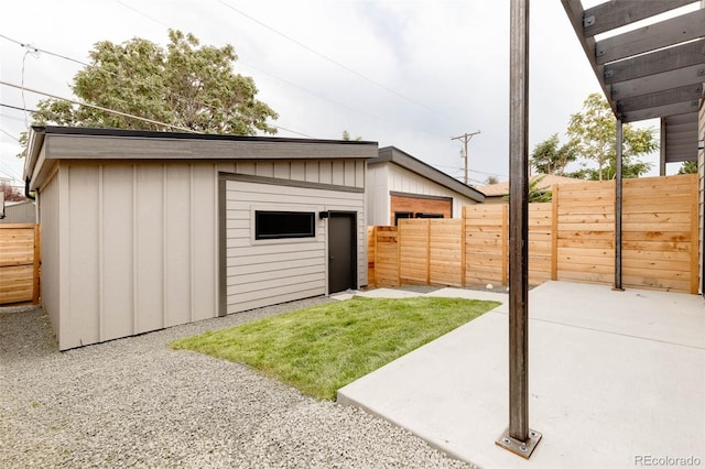 exterior space with an outdoor structure and a patio