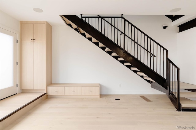 staircase featuring wood-type flooring