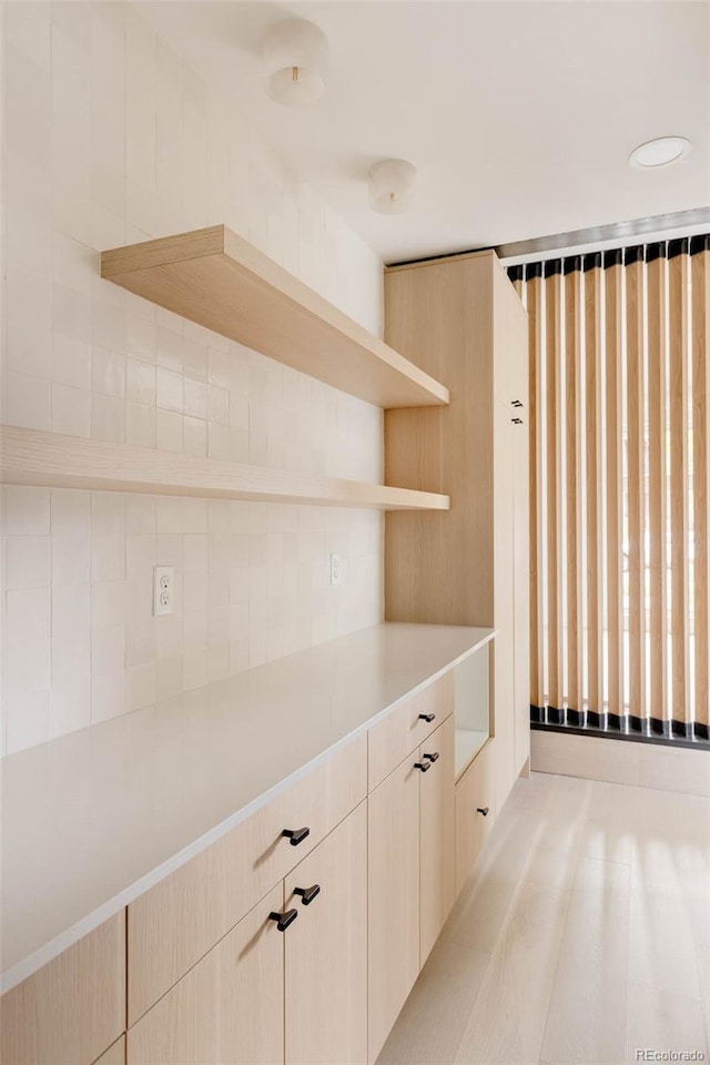 kitchen with light countertops and open shelves