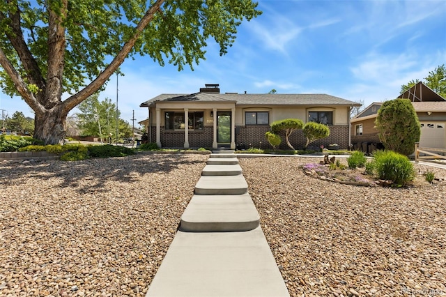 9598 Lowell Blvd, Westminster, CO 80031 - view of front of home featuring brick siding, a chimney, and stucco siding