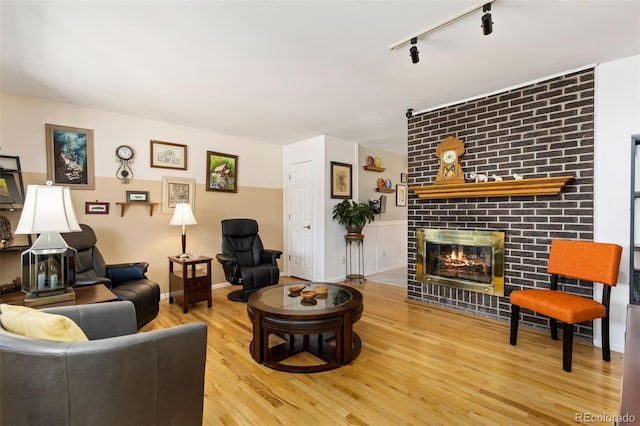 9598 Lowell Blvd, Westminster, CO 80031 - living room with wood finished floors, track lighting, and a brick fireplace