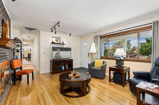 9598 Lowell Blvd, Westminster, CO 80031 - living area featuring light wood finished floors, track lighting, and baseboards