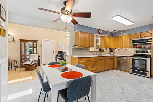 9598 Lowell Blvd, Westminster, CO 80031 - kitchen with stainless steel appliances, light countertops, light marble finish floors, and backsplash