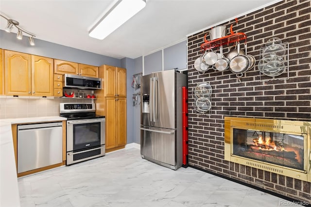 9598 Lowell Blvd, Westminster, CO 80031 - kitchen with stainless steel appliances, light marble finish floors, light countertops, light brown cabinets, and backsplash