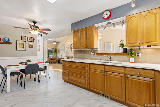 9598 Lowell Blvd, Westminster, CO 80031 - kitchen featuring a ceiling fan, a sink, light marble finish flooring, light countertops, and wainscoting