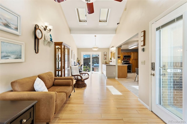 9598 Lowell Blvd, Westminster, CO 80031 - living room with a ceiling fan, light wood-style floors, and a high ceiling
