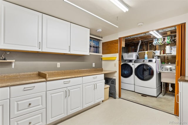 9598 Lowell Blvd, Westminster, CO 80031 - laundry area featuring washing machine and clothes dryer and cabinet space