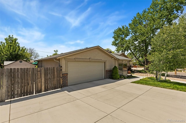 9598 Lowell Blvd, Westminster, CO 80031 - view of front of home with brick siding, an attached garage, driveway, and stucco siding