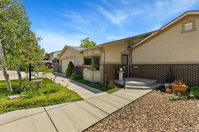 9598 Lowell Blvd, Westminster, CO 80031 - view of side of property with stucco siding, brick siding, and a garage