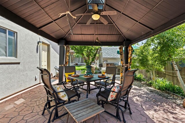 9598 Lowell Blvd, Westminster, CO 80031 - fenced backyard featuring a gazebo, outdoor dining area, a patio, area for grilling, and a ceiling fan