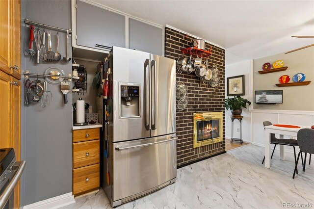 9598 Lowell Blvd, Westminster, CO 80031 - kitchen featuring stainless steel fridge, light marble finish flooring, a fireplace, and ceiling fan