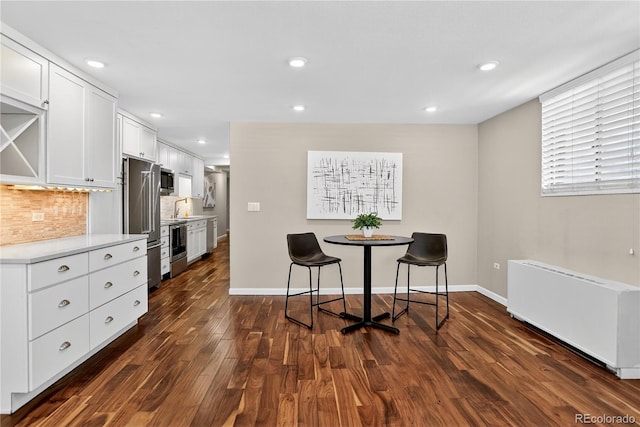 909 N Logan St Unit 1B, Denver, CO 80203 - dining space with dark wood finished floors, recessed lighting, and radiator