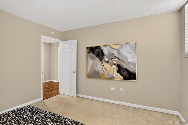 909 N Logan St Unit 1B, Denver, CO 80203 - unfurnished bedroom featuring carpet flooring and baseboards
