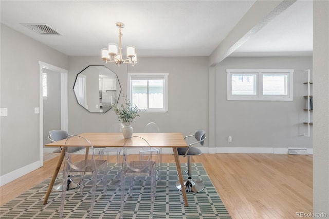 4933 Grove St, Denver, CO 80221 - office featuring wood finished floors, a chandelier, and baseboards
