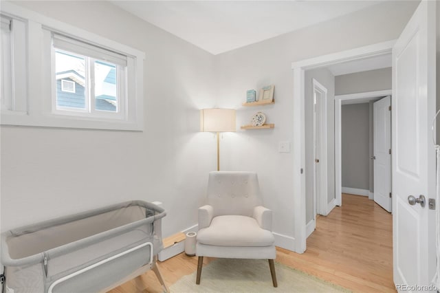 4933 Grove St, Denver, CO 80221 - living area featuring baseboards and light wood finished floors