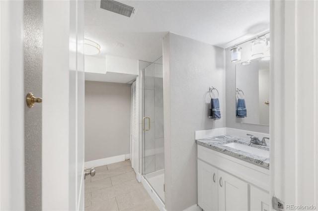 4933 Grove St, Denver, CO 80221 - bathroom featuring a stall shower, vanity, tile patterned floors, and baseboards