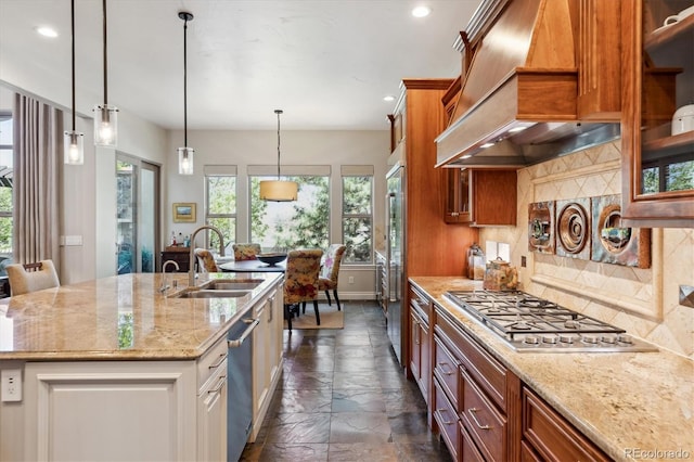 kitchen featuring light stone countertops, ventilation hood, a sink, backsplash, and stone tile flooring